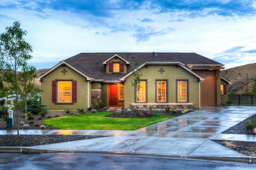 pexels-photo-1396132-1396132 Beautifully illuminated modern home exterior with a lush lawn and wet driveway in Boise, Idaho.